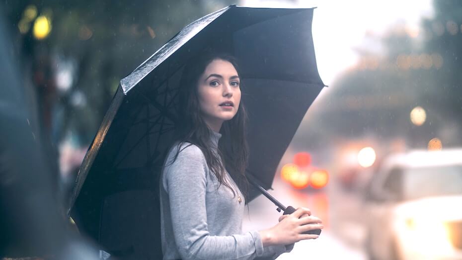 This image has an empty alt attribute; its file name is unsplash-jon-ly-woman-waiting-in-rain-with-umbrella-111219.jpg